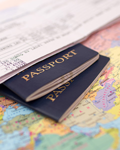 A couple of passports on top of a travel map.